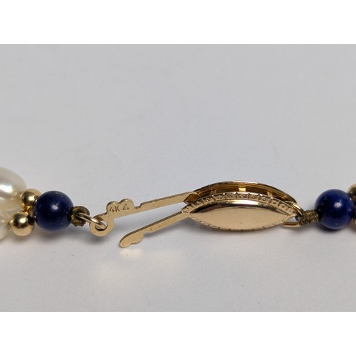 153 - Freshwater pearl and lapis lazuli necklace and pair of pendant earrings, each with 14ct gold fitting... 