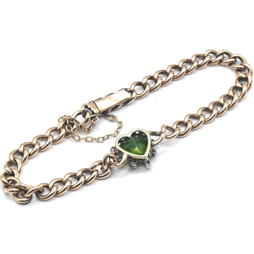 180 - Yellow metal bracelet with heart-shaped green paste and diamond cluster, yellow metal tests positive... 