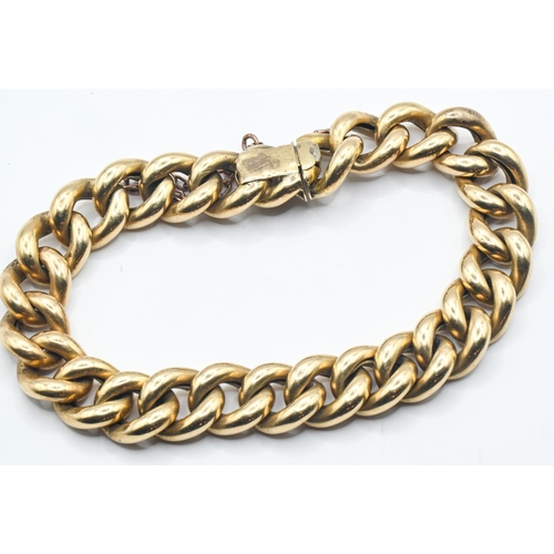 183 - Yellow metal curb link bracelet, tests positive for 18ct gold, with a yellow metal safety chain, gro... 