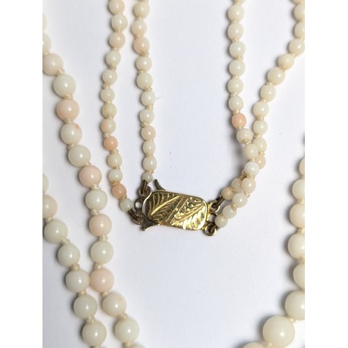 196 - 9ct gold clasped white coral double strand necklace, clasp stamped 9CT, length 520mm