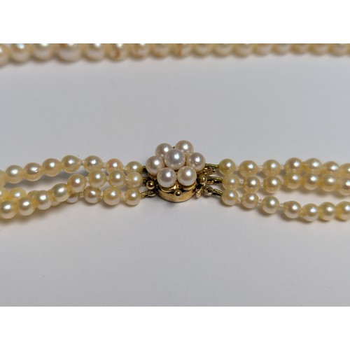 234 - Triple strand pearl necklace with 9ct gold clasp, clasp tongue stamped 375, inner length 420mm... 