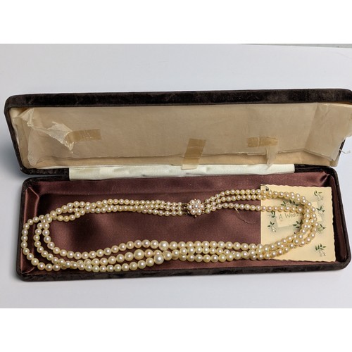 234 - Triple strand pearl necklace with 9ct gold clasp, clasp tongue stamped 375, inner length 420mm... 