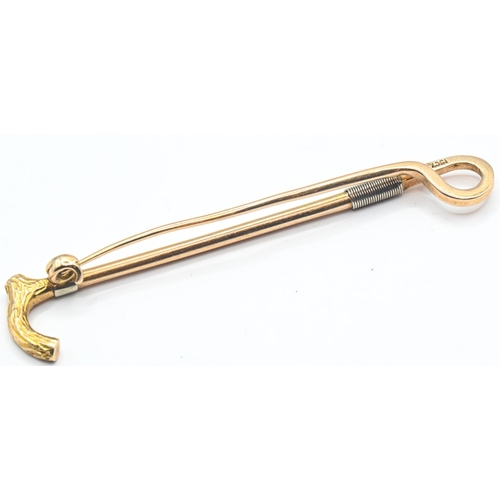 238 - 15ct gold stock pin designed as a riding crop, stamped 15CT, length 65mm, 5.88 grams