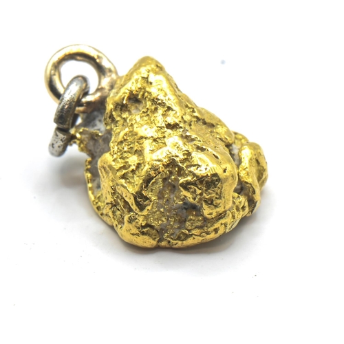 242 - Small nugget of high grade yellow metal, with base metal loop and bale, gross weight 1.96 grams