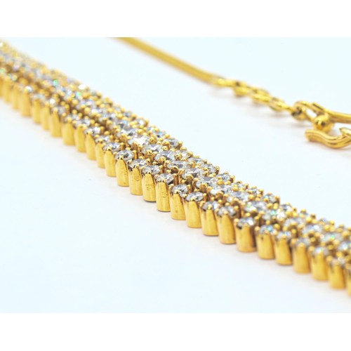 75 - Yellow metal and diamond necklace, the front designed as a line of three rows of brilliant-cut diamo... 