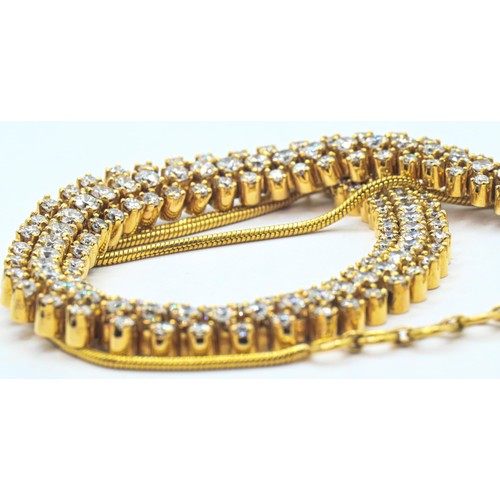 75 - Yellow metal and diamond necklace, the front designed as a line of three rows of brilliant-cut diamo... 