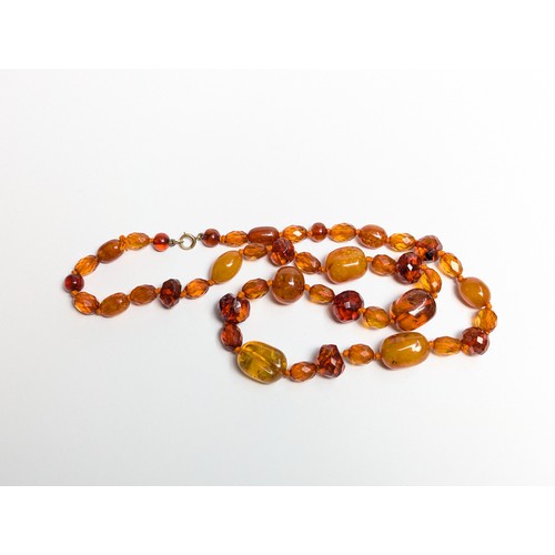 289 - Honey colour amber bead necklace with 9CT marked clasp and a pair of gilt metal mounted earrings, gr... 