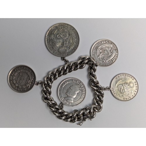 290 - 900 grade Chilean silver curb link bracelet suspending five South American silver coins, including t... 