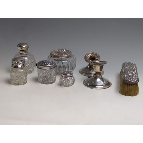 341 - Five silver topped cut glass vanity pots, a silver mounted clothes brush and a pair of scrap candles... 