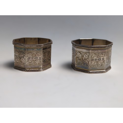 391 - Pair of Edwardian silver napkin rings, William M Hayes, Birmingham 1904, each octagonal ring engrave... 