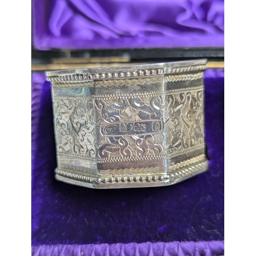 391 - Pair of Edwardian silver napkin rings, William M Hayes, Birmingham 1904, each octagonal ring engrave... 