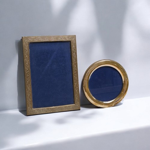 394 - Two Italian silver photo frames, including one polished circular frame and a rectangular photo with ... 