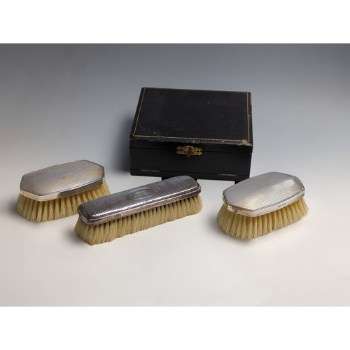 396 - Cased George V silver backed engine-turned pair of brushes and comb mount, Charles S Green & Co ... 