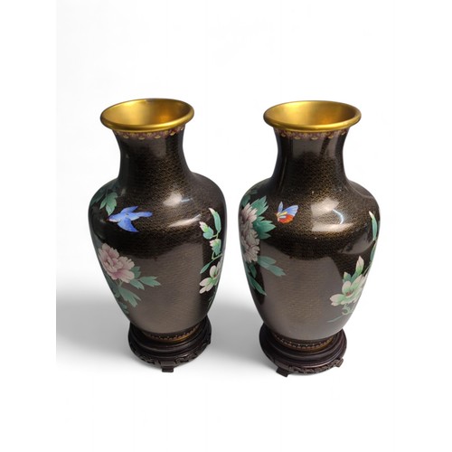 438 - Pair of C20th Chinese cloisonné vases decorated with peonies, butterflies and birds on a black groun... 