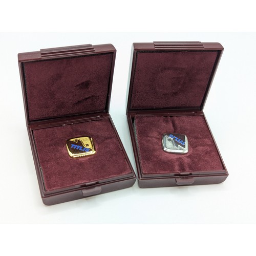 197A - Two Huguenin Frères 'Titlis' pin badges, comprising: an 18ct gold stamped verso '750 HF,'  4.95 gram... 