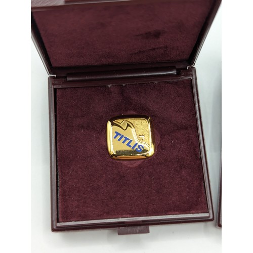 197A - Two Huguenin Frères 'Titlis' pin badges, comprising: an 18ct gold stamped verso '750 HF,'  4.95 gram... 