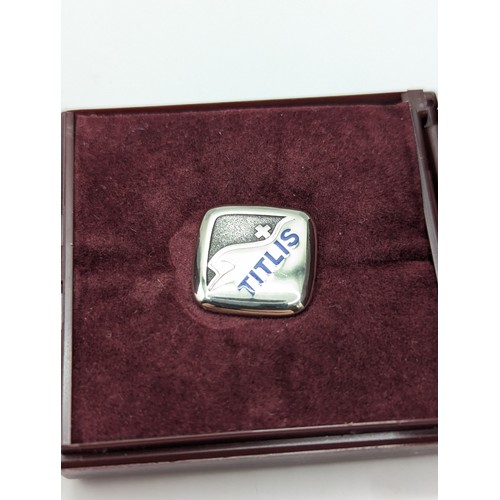 197A - Two Huguenin Frères 'Titlis' pin badges, comprising: an 18ct gold stamped verso '750 HF,'  4.95 gram... 