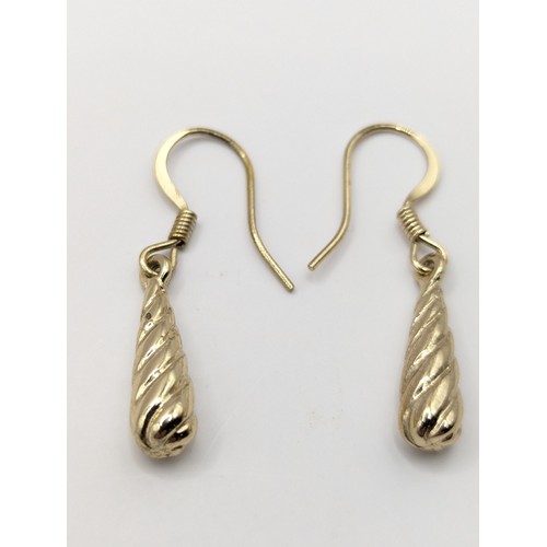 251A - Pair of yellow metal twist drop earrings, gross weight 3 grams