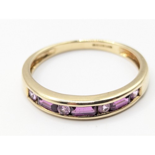 173A - Half eternity 'stacker' ring channel set with tourmaline and pink sapphire. Size P. Gross weight 1.7... 