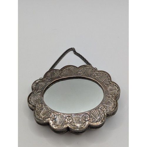 365A - Turkish 900-grade silver mounted wedding mirror, with repoussé decoration, stamped 'ORNEK 900', widt... 