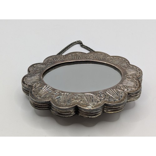 365A - Turkish 900-grade silver mounted wedding mirror, with repoussé decoration, stamped 'ORNEK 900', widt... 