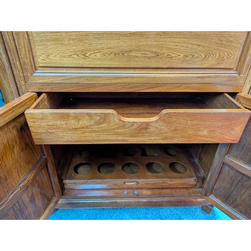 25 - Rosewood cocktail cabinet with various storage drawers and cupboards for a variety of glasses/bottle... 