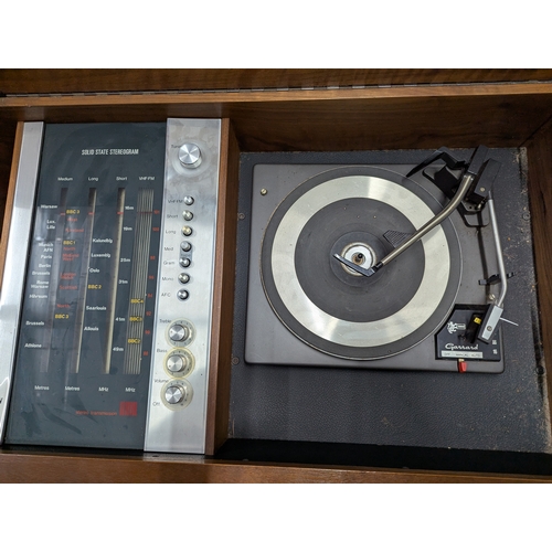 36 - Mid-century teak cased HMV Solid State Stereogram, with Garrard 3000 turntable 143cm by 48cm by 60 c... 