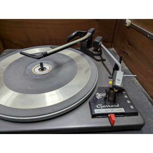 36 - Mid-century teak cased HMV Solid State Stereogram, with Garrard 3000 turntable 143cm by 48cm by 60 c... 