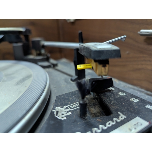 36 - Mid-century teak cased HMV Solid State Stereogram, with Garrard 3000 turntable 143cm by 48cm by 60 c... 