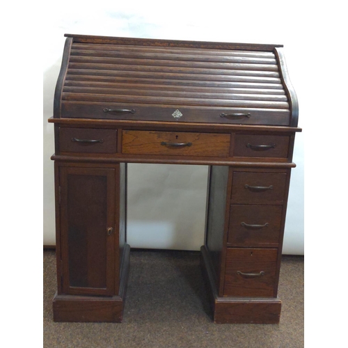 653A - Child's roll top pedestal desk, W70cm D42cm H86cm.