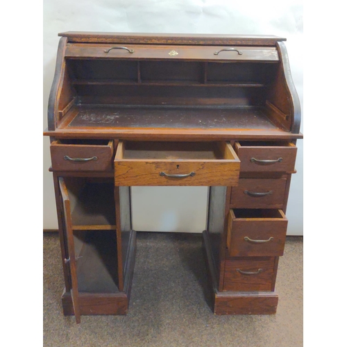 653A - Child's roll top pedestal desk, W70cm D42cm H86cm.