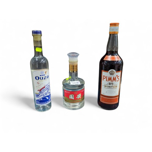 669 - Three bottles, including Keo ouzo 50cl, Pimm's No 3 Winter 1 litre and Chinese 500ml bottle of 52% a... 