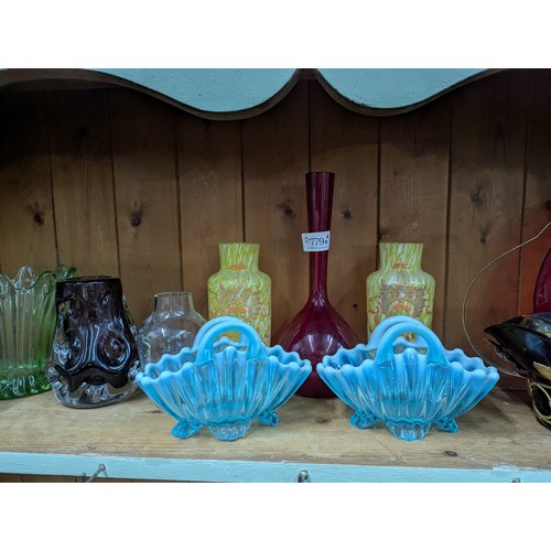 779 - Assorted coloured glass on shelf