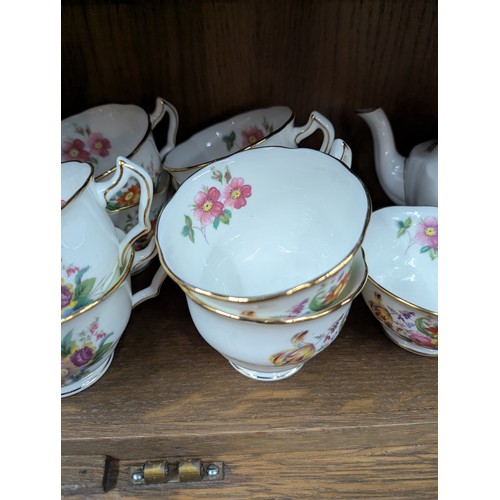 792 - Crescent tea service for eight with two cream jugs, six side plates and a cake plate