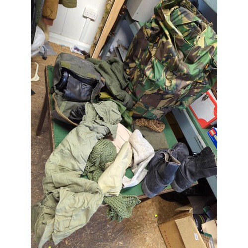 134 - Rucksack with military contents inc. boots (M), socks, webbing belt, spare clothes, dressings etc.