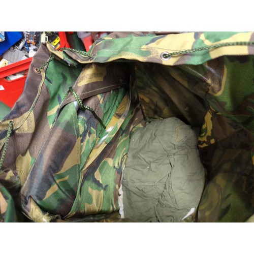 134 - Rucksack with military contents inc. boots (M), socks, webbing belt, spare clothes, dressings etc.