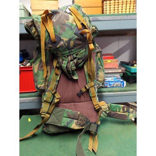 134 - Rucksack with military contents inc. boots (M), socks, webbing belt, spare clothes, dressings etc.