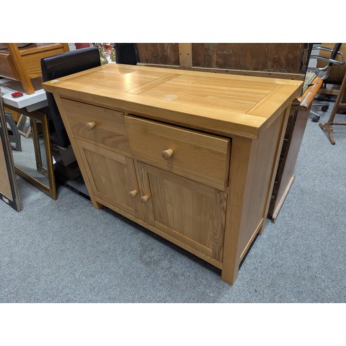 827 - Oak sideboard with two drawers over two doors, width 110cm, depth 46cm, height 85cm