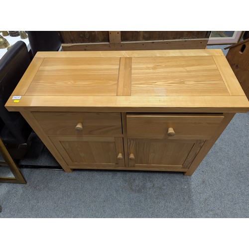 827 - Oak sideboard with two drawers over two doors, width 110cm, depth 46cm, height 85cm