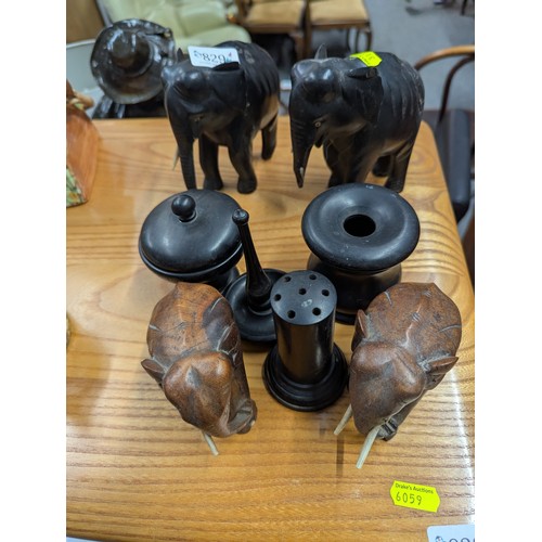 829 - Ebonised part dressing table set, two ebonised elephants and two other elephants