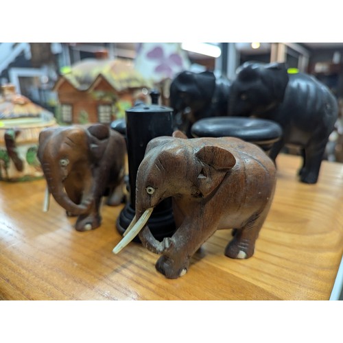 829 - Ebonised part dressing table set, two ebonised elephants and two other elephants