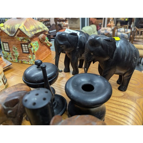 829 - Ebonised part dressing table set, two ebonised elephants and two other elephants