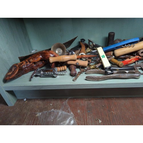 197 - Bottom shelf of mostly bottle openers, plus nut crackers etc