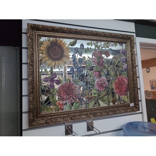 562 - Gilt framed mirror with applied floral decoration to glass 82 x 62cm