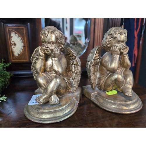 715 - Pair of gilt-painted cherub bookends.