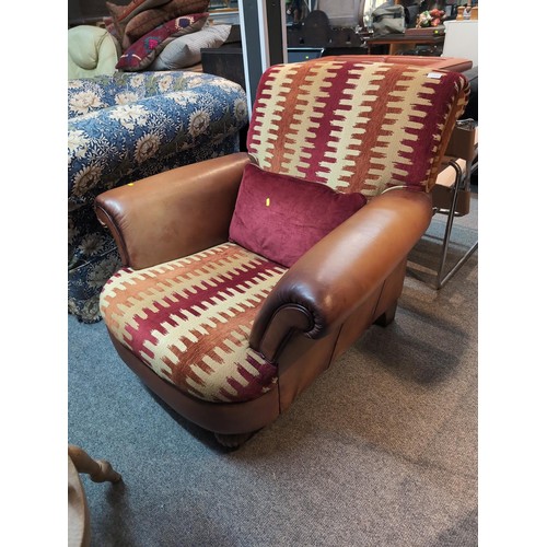 733 - Large leather and textile upholstered armchair with matching cushion W100 x D105 x H88cm approx.