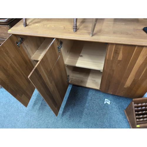 805 - Light oak three drawer sideboard / cabinet, plastic castors, width 125cm, depth 51cm, height 79cm