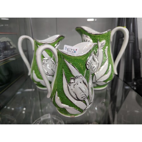 622 - Three graduated tulip jugs