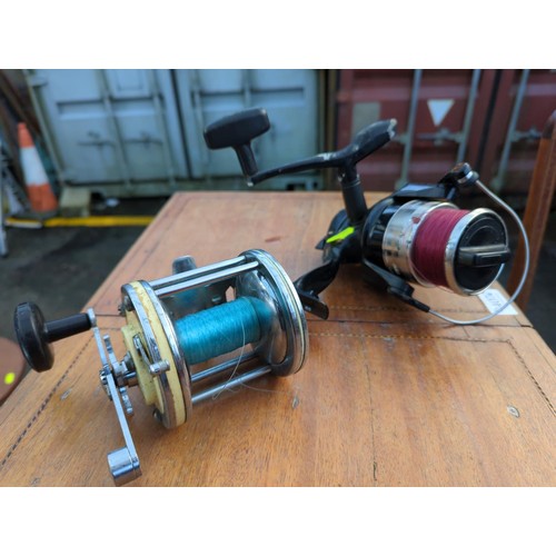 409 - 2 fishing reels. Captain Mitchell 624 &Impact IM65