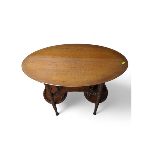 29 - Occasional table, oval top over under-tier with scrolled foliate edges, connected to two circular lo... 